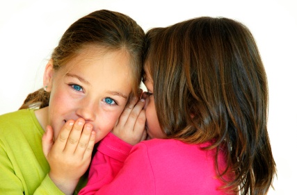 Auditory processing:Young girl whispering to another